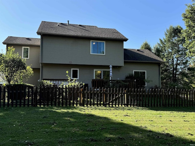 rear view of property featuring a yard