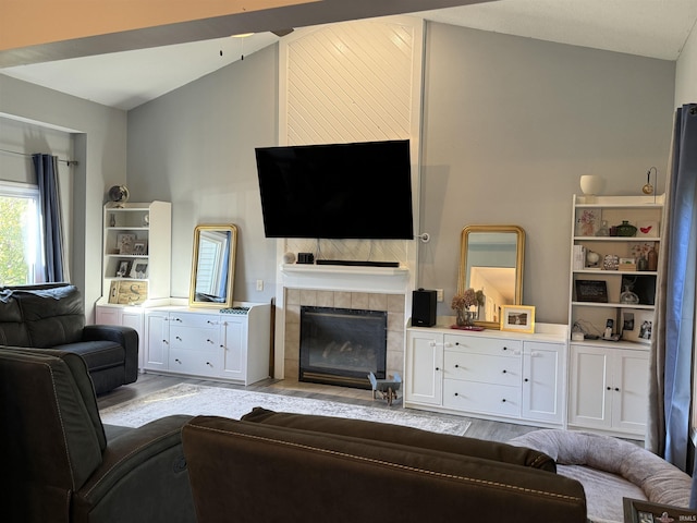 living room with a fireplace and vaulted ceiling