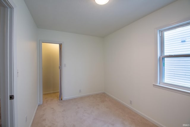 unfurnished room with light colored carpet