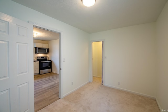 spare room with light colored carpet