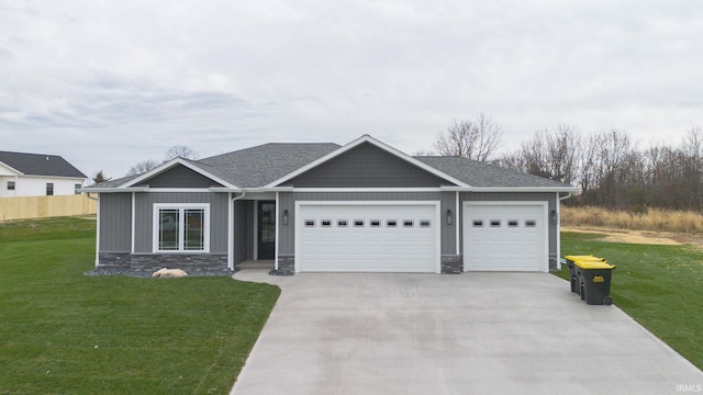 view of front of property with a front yard and a garage