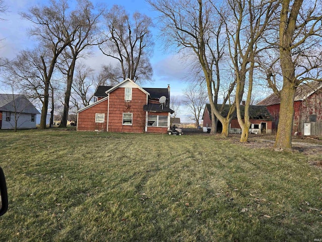 property exterior at dusk with a yard