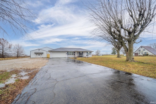 single story home featuring a front lawn and a garage