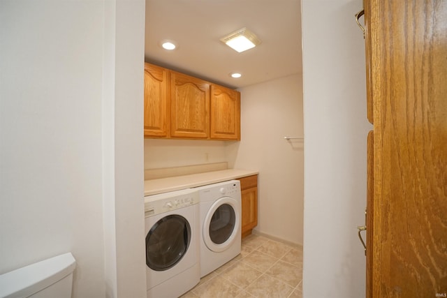 washroom featuring cabinets and washing machine and clothes dryer