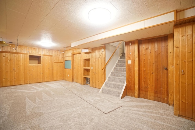 basement with wood walls and carpet floors