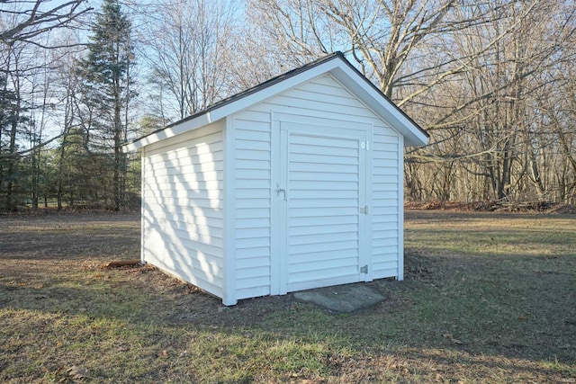 view of outdoor structure featuring a lawn