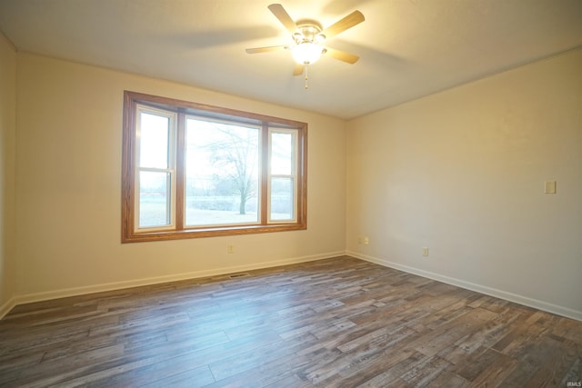 empty room with ceiling fan and dark wood-type flooring