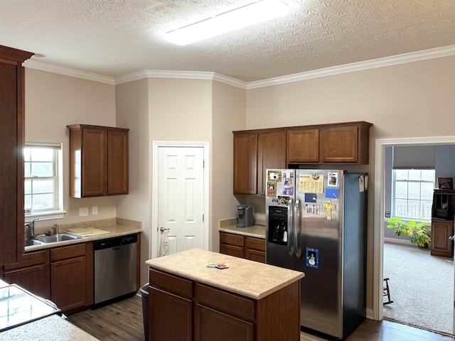 kitchen featuring crown molding, sink, a textured ceiling, and appliances with stainless steel finishes