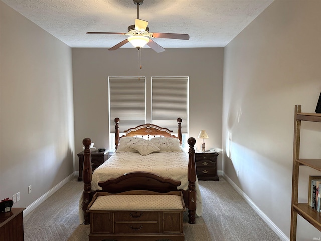 bedroom featuring ceiling fan, a textured ceiling, and light carpet