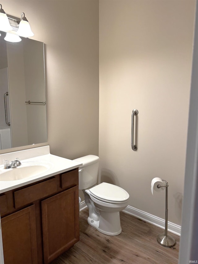 bathroom featuring vanity, toilet, and wood-type flooring