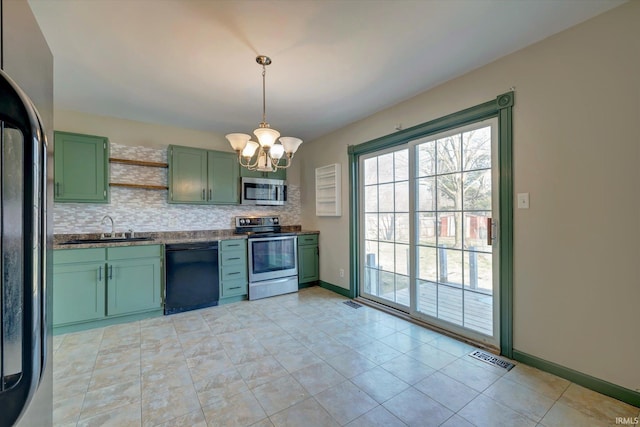 kitchen featuring green cabinets, sink, hanging light fixtures, decorative backsplash, and stainless steel appliances