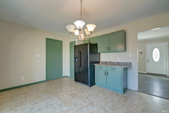 kitchen with decorative light fixtures, an inviting chandelier, and black refrigerator with ice dispenser