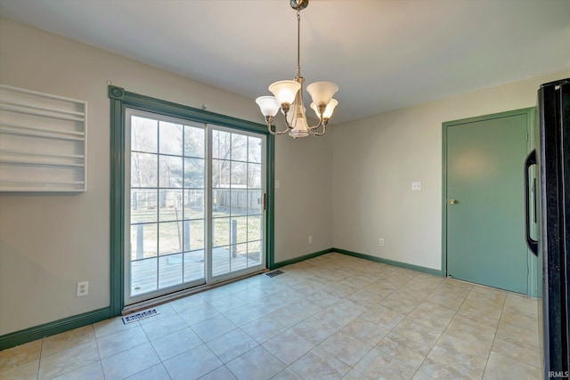 unfurnished room featuring light tile patterned flooring and a notable chandelier