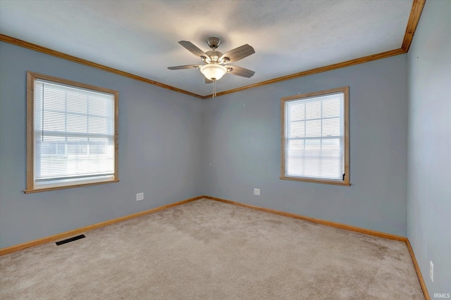 carpeted empty room featuring ceiling fan and ornamental molding