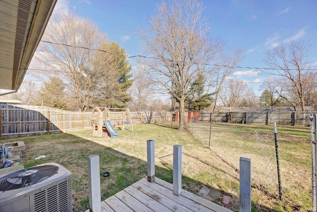 view of yard with a playground and central AC unit