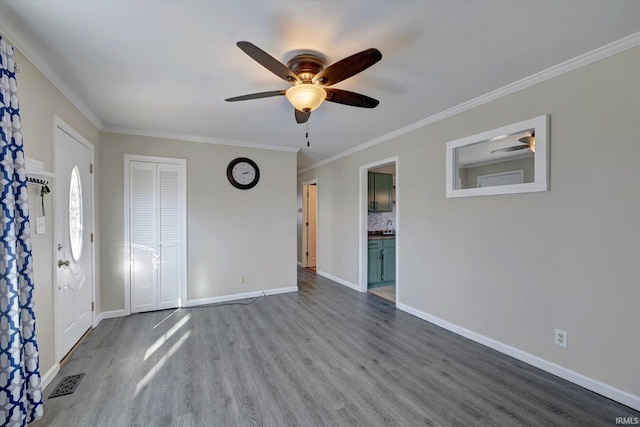 unfurnished bedroom with hardwood / wood-style floors, crown molding, ensuite bath, ceiling fan, and a closet