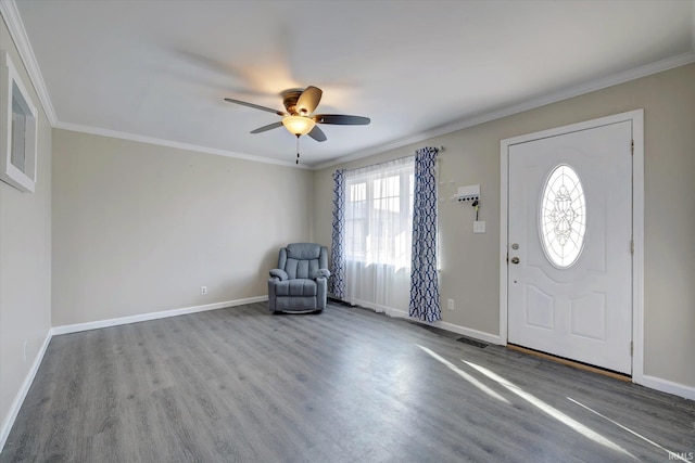 entrance foyer featuring ceiling fan, wood-type flooring, and ornamental molding