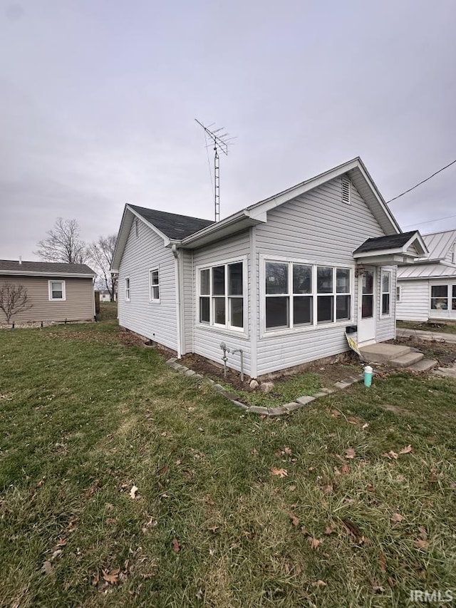 rear view of property with a yard