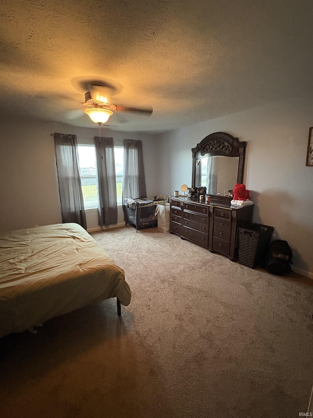 carpeted bedroom featuring a textured ceiling and ceiling fan