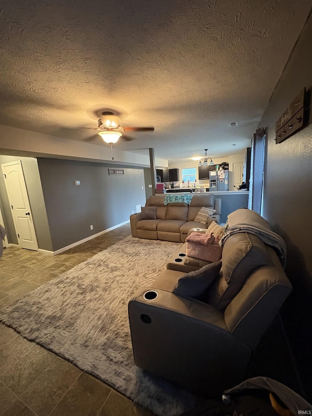 living room featuring a textured ceiling and ceiling fan