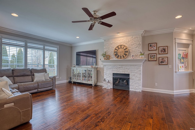 living room with ceiling fan, a fireplace, dark hardwood / wood-style floors, and ornamental molding