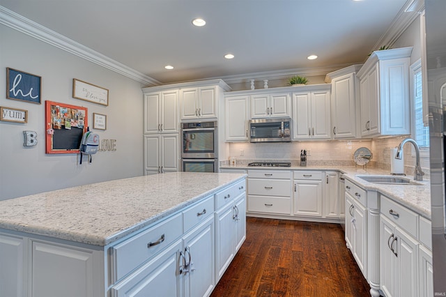 kitchen featuring dark hardwood / wood-style flooring, white cabinetry, sink, and stainless steel appliances