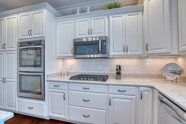 kitchen featuring white cabinetry, crown molding, light stone countertops, and appliances with stainless steel finishes