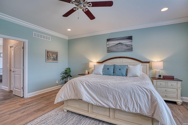 bedroom featuring ceiling fan, dark wood-type flooring, and ornamental molding