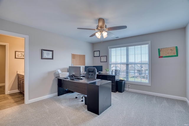 carpeted office with ceiling fan