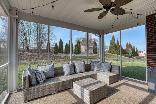 sunroom featuring ceiling fan and plenty of natural light