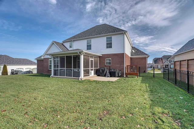 back of house featuring a lawn and a sunroom