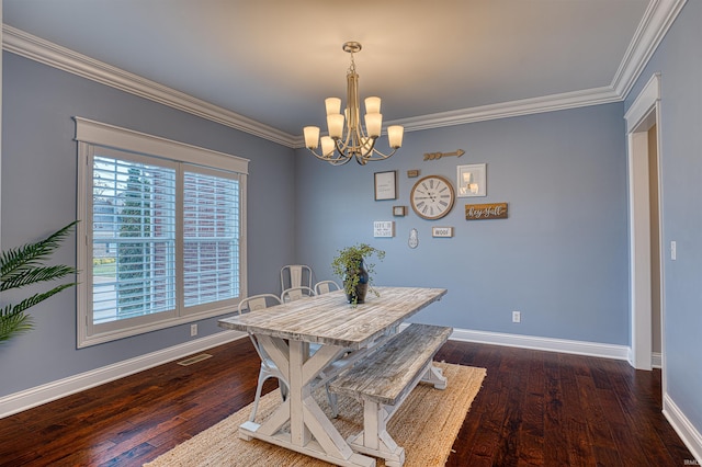 dining area with dark hardwood / wood-style flooring, crown molding, and an inviting chandelier