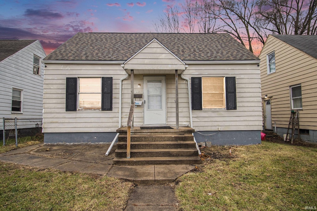 bungalow-style home featuring a yard