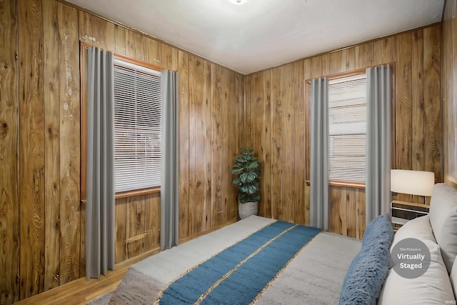 bedroom featuring wood walls