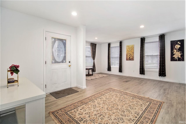 entrance foyer with light wood finished floors, baseboards, and recessed lighting