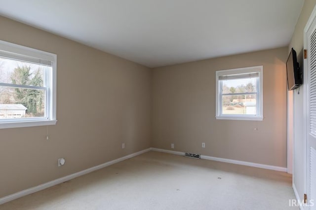 unfurnished bedroom featuring light carpet