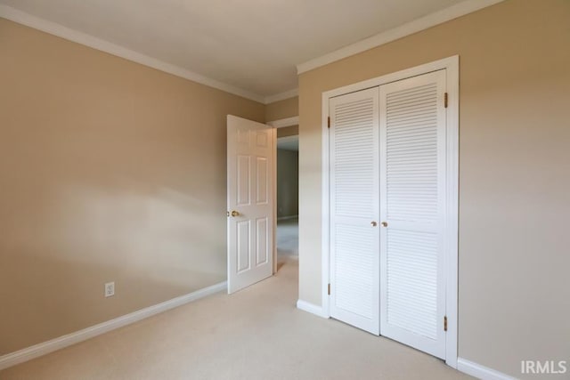 unfurnished bedroom with light carpet, a closet, and ornamental molding