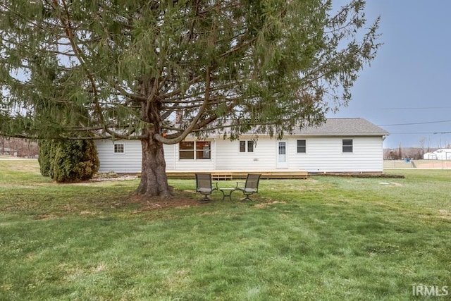 back of house with a yard and a deck