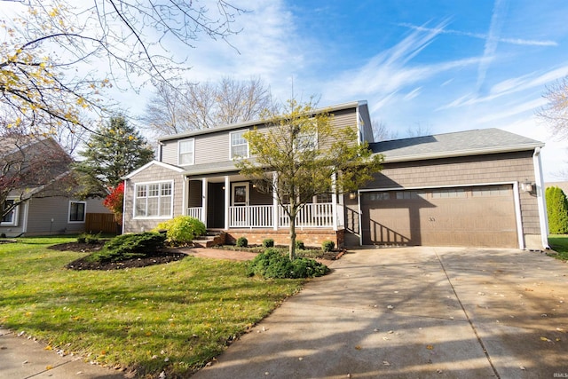 front of property featuring covered porch, a garage, and a front yard