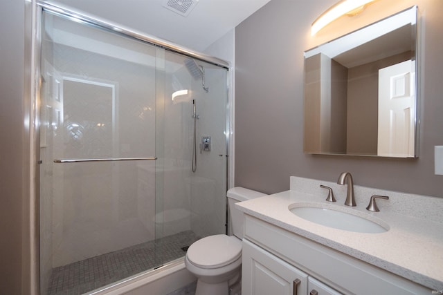 bathroom featuring vanity, toilet, and walk in shower