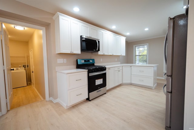 kitchen featuring white cabinetry, ornamental molding, light wood-type flooring, and appliances with stainless steel finishes