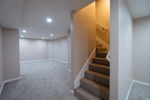 stairs featuring carpet flooring