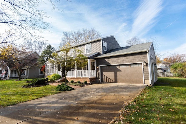 view of front of house with a front yard, a porch, and a garage