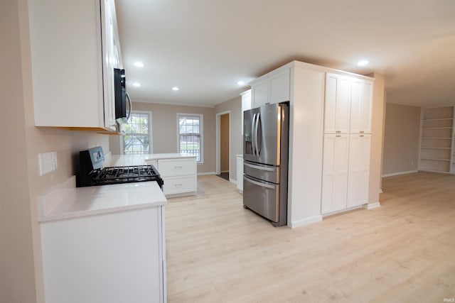 kitchen featuring white cabinetry, range, stainless steel refrigerator with ice dispenser, and light hardwood / wood-style flooring