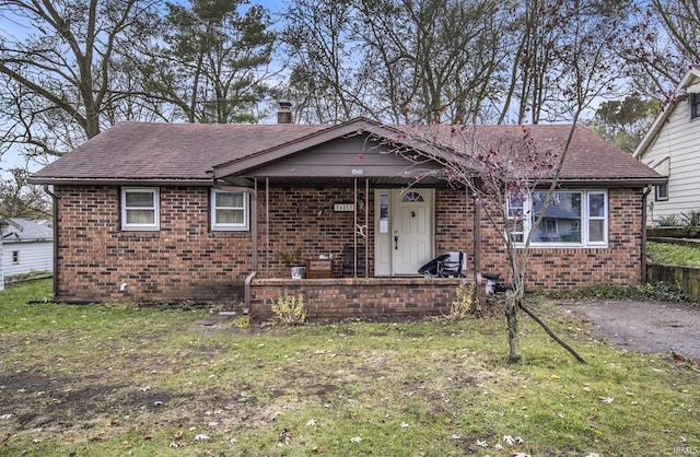 view of front of house featuring a front yard and covered porch