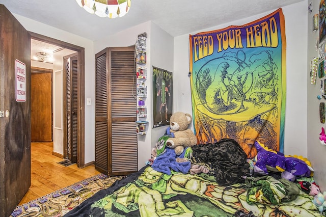 bedroom featuring light hardwood / wood-style floors and a closet