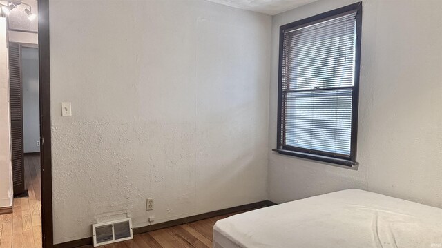 bedroom featuring wood-type flooring