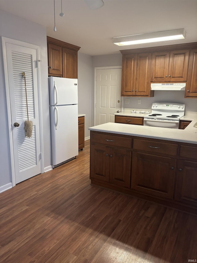 kitchen with dark wood-type flooring and white appliances