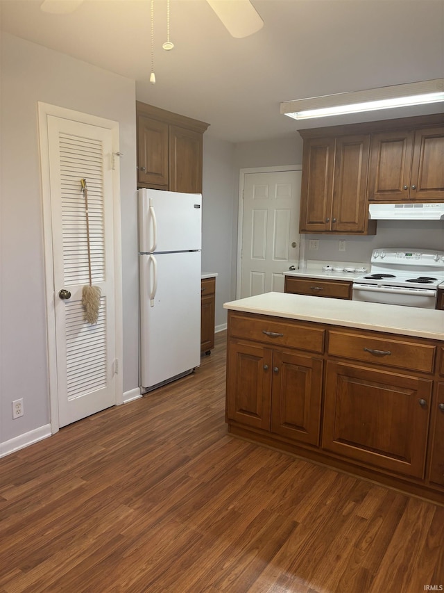 kitchen featuring ceiling fan, white appliances, and dark hardwood / wood-style floors