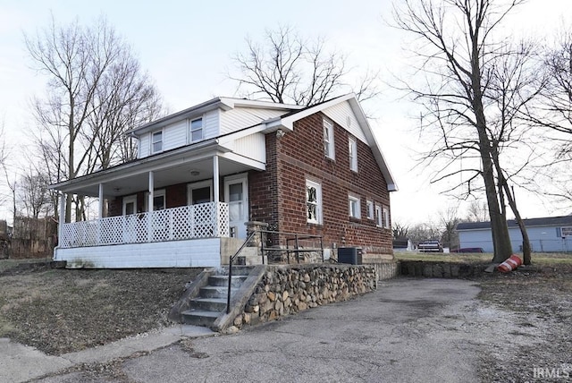 view of front of property featuring covered porch and central air condition unit